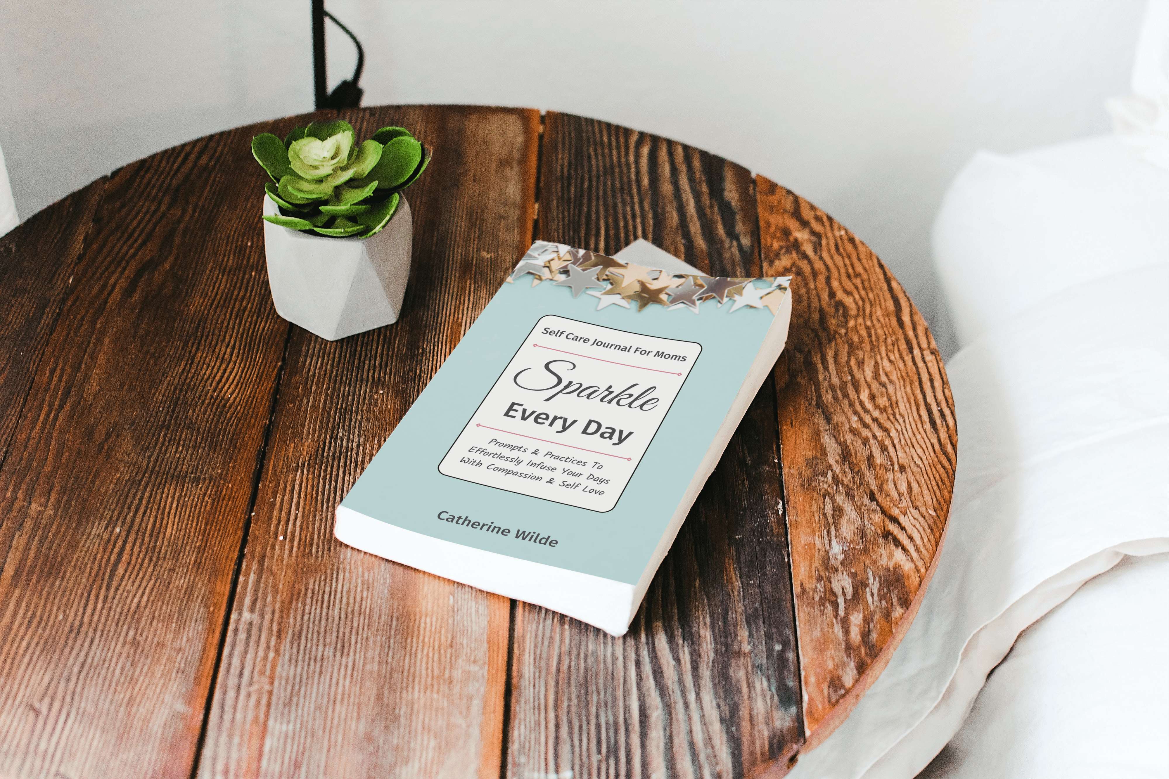 Sparkle Every Day - Self Care Journal For Moms on a wooden table