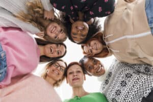 Women standing in a circle feeling empowered by women's wellness